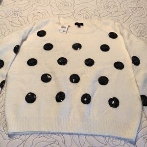 White sweater with black dots.